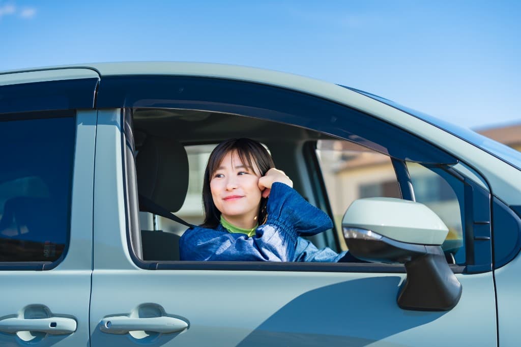 車の窓から微笑む女性